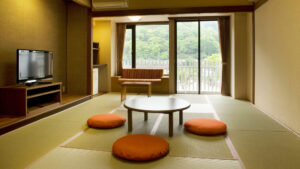 Tatami room with low table, floor cushions, and window