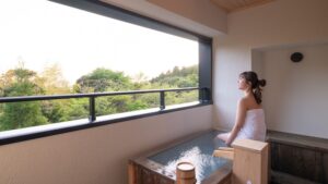 Femme assise à côté d’un bain en plein air privé