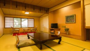 Tatami room with low table, floor cushions, and chairs
