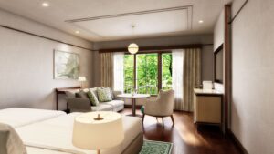 Habitación con sofá, silla y zona de estar junto a la ventana