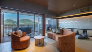 Seating area with chairs and sofa by balcony windows