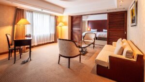 Chambre avec canapé, chaises, bureau et espace lit