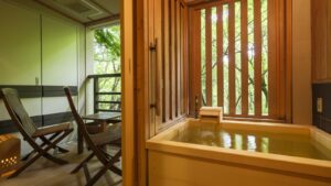 Private wooden bath beside a balcony seating area
