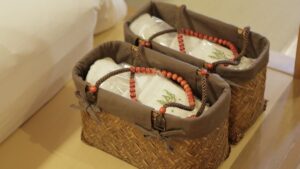 Two baskets with folded yukata near a bed