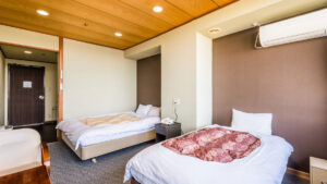 Lits jumeaux dans une chambre avec plafond en bois