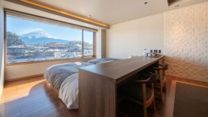 Camera da letto con due letti singoli e finestra con vista sulle montagne