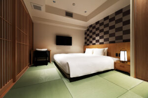 Low bed in tatami guest room with television