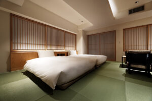 Two low beds on tatami flooring in guest room