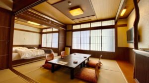 Tatami room with low table, cushions, and beds