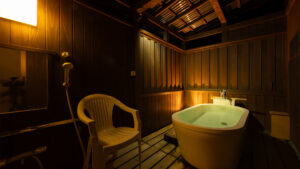 Private bath on wooden deck with shower and chair
