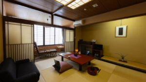 Tatami room with low table, chairs, and sofa