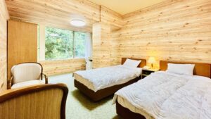 Letti singoli in una camera con pannelli in legno