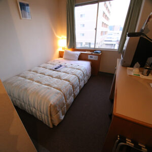 Single bed in a compact guest room