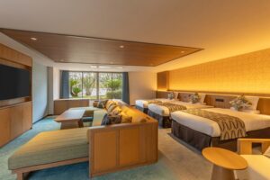 Guest room with three beds and seating area