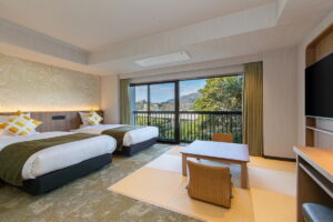 Twin beds beside tatami seating and balcony window