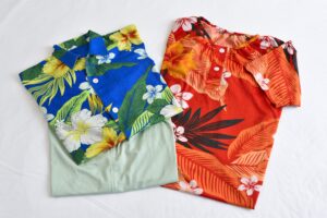 Two colorful yukata laid out on a bed