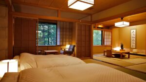 Beds beside a tatami seating area in a guest room