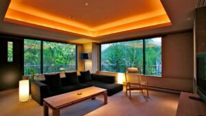 Living area with sofa, chair, table, and large windows