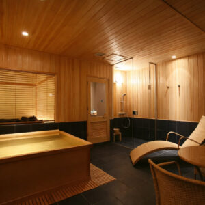 Private wooden bath with lounge chair in room