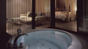 圆形客房内浴池，木格栅后方可见床铺