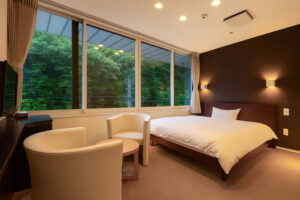 客房内大窗旁的床和椅子