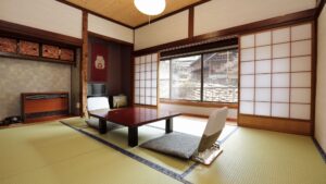 Tatami-Zimmer mit niedrigem Tisch und Bodenstühlen