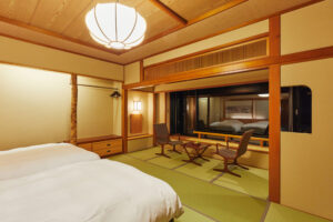 Letti in una camera in tatami con tavolo e sedie