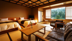 Twin beds and seating area by a large window