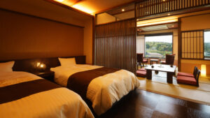 Twin beds beside a tatami seating area in room