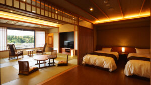 Twin beds beside tatami seating area in guest room