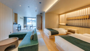 Guest room with twin beds and sofa seating area