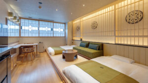 Guest room with twin beds and sofa seating area