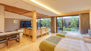 Twin beds in a spacious room facing a garden.