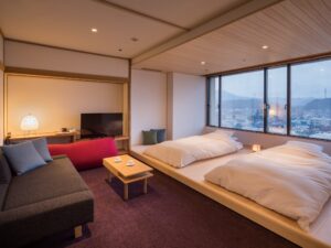 Guest room with twin floor beds and sofa