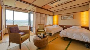 Twin beds and chairs in a tatami guest room