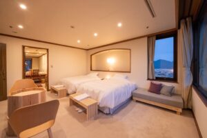 Twin beds in a spacious guest room by windows