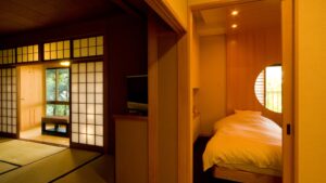Bedroom with a bed beside a tatami room