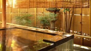 Private open-air bath beside bamboo fencing