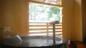 Private round bath on a balcony with trees outside