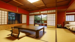 Tatami room with low table and chairs, beds beside.