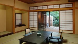 Tatami room with low table and chairs by open terrace