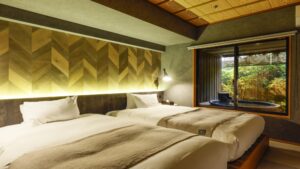 Twin beds beside a window with private bath