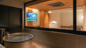 Bañera redonda privada junto a una ventana que da a la habitación