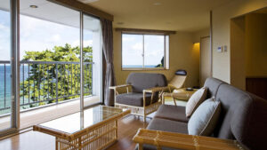 Seating area with sofas beside balcony ocean view