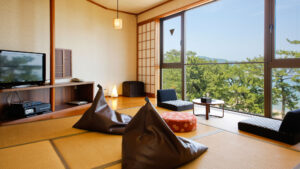 Tatami room with floor cushions by large window