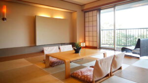 Tatami room with low table, floor chairs, and window