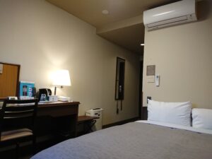 Bed beside desk and lamp in guest room