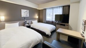 Twin beds in a guest room with TV