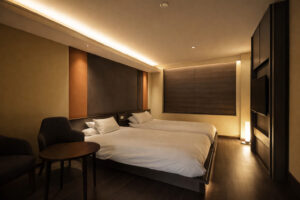 Zwei Einzelbetten in einem sanft beleuchteten Gästezimmer