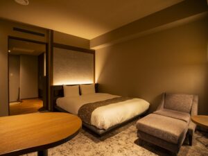 ダブルベッドとアームチェアのある寝室